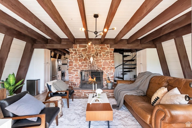 10481 E Spring Creek Dr Unit 722, Heber City, UT 84032 - living room with beam ceiling, wood walls, light hardwood / wood-style flooring, and a stone fireplace