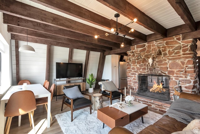 10481 E Spring Creek Dr Unit 722, Heber City, UT 84032 - living room featuring light wood-type flooring, beam ceiling, wood walls, and a fireplace
