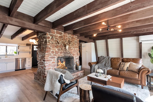 10481 E Spring Creek Dr Unit 722, Heber City, UT 84032 - living room with beam ceiling, light hardwood / wood-style flooring, a stone fireplace, a wall mounted air conditioner, and sink