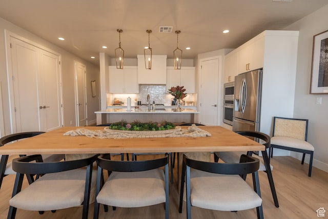 5398 S Aquamarine Ln, St George, UT 84790 - kitchen featuring white cabinetry, hanging light fixtures, sink, tasteful backsplash, and appliances with stainless steel finishes