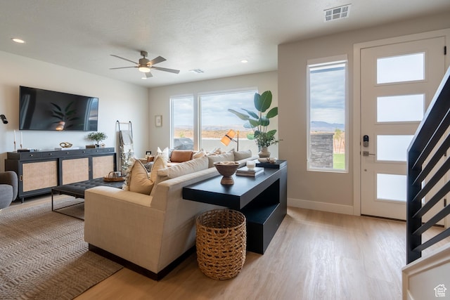 5398 S Aquamarine Ln, St George, UT 84790 - living room with light hardwood / wood-style flooring, ceiling fan, and a textured ceiling