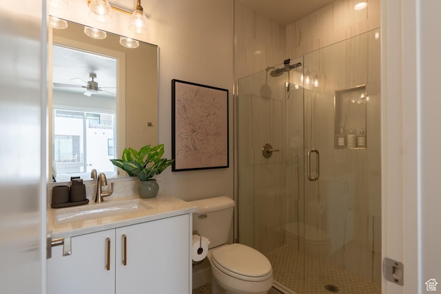 5398 S Aquamarine Ln, St George, UT 84790 - bathroom with ceiling fan, vanity, a shower with door, and toilet