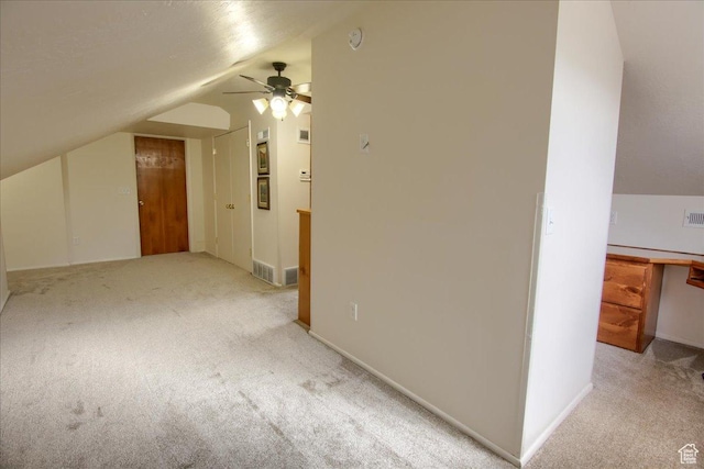 additional living space featuring lofted ceiling, ceiling fan, and light colored carpet