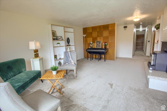 sitting room with carpet floors and a textured ceiling