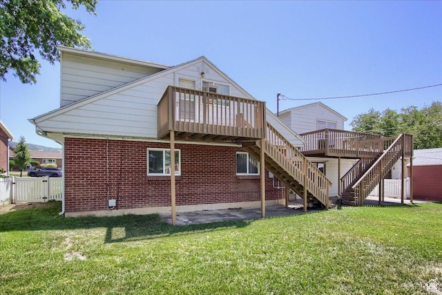rear view of property with a lawn and a wooden deck