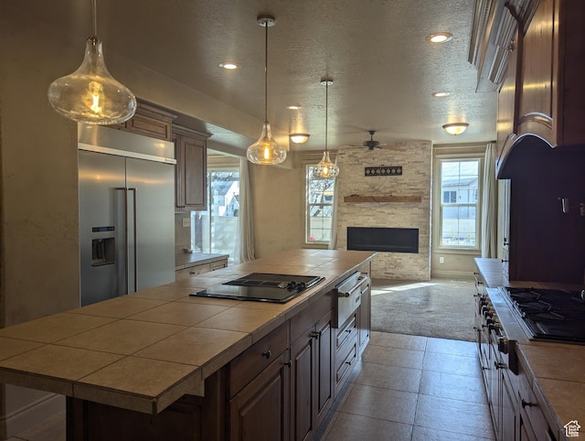 3006 E Somerset Dr, Spanish Fork, UT 84660 - kitchen featuring open floor plan, a ceiling fan, built in fridge, tile counters, and black electric stovetop