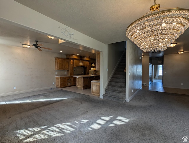 3006 E Somerset Dr, Spanish Fork, UT 84660 - unfurnished living room featuring baseboards, stairway, a textured ceiling, light colored carpet, and ceiling fan with notable chandelier