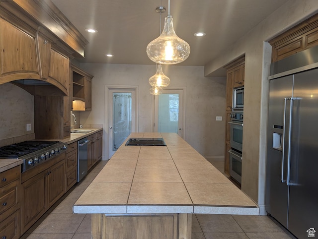 3006 E Somerset Dr, Spanish Fork, UT 84660 - kitchen featuring built in appliances, tile counters, tile patterned floors, a center island, and a sink