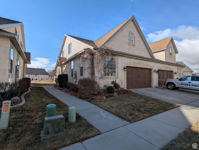 view of side of home featuring a garage and a yard