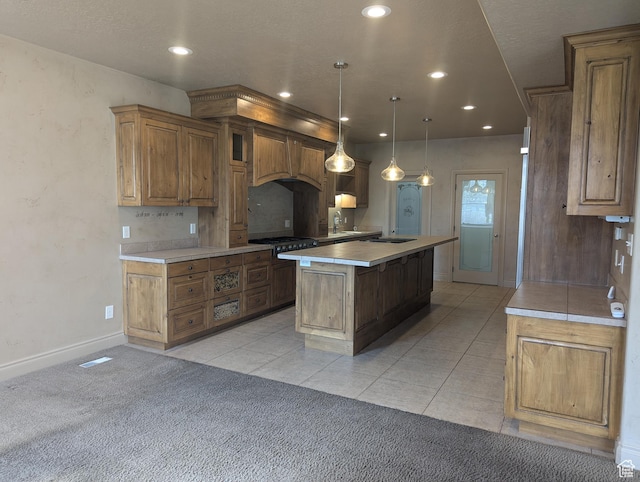 3006 E Somerset Dr, Spanish Fork, UT 84660 - kitchen with a kitchen island, custom exhaust hood, light carpet, light countertops, and cooktop