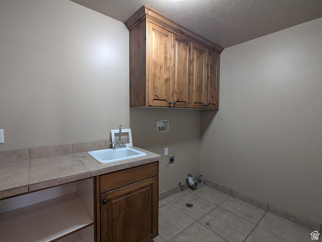 3006 E Somerset Dr, Spanish Fork, UT 84660 - clothes washing area with washer hookup, a sink, a textured ceiling, cabinet space, and electric dryer hookup
