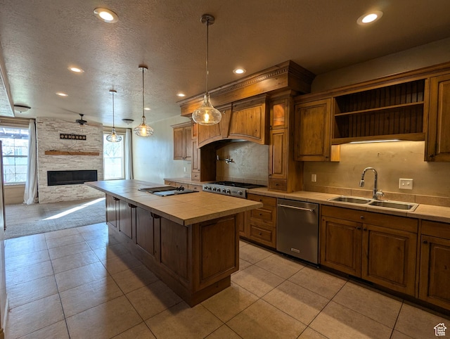 3006 E Somerset Dr, Spanish Fork, UT 84660 - kitchen with stainless steel dishwasher, a fireplace, a textured ceiling, a sink, and tile counters