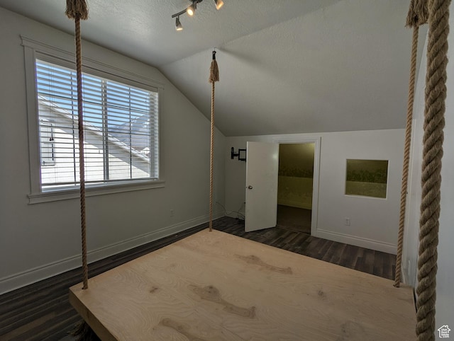 3006 E Somerset Dr, Spanish Fork, UT 84660 - additional living space with baseboards, wood finished floors, vaulted ceiling, and a textured ceiling