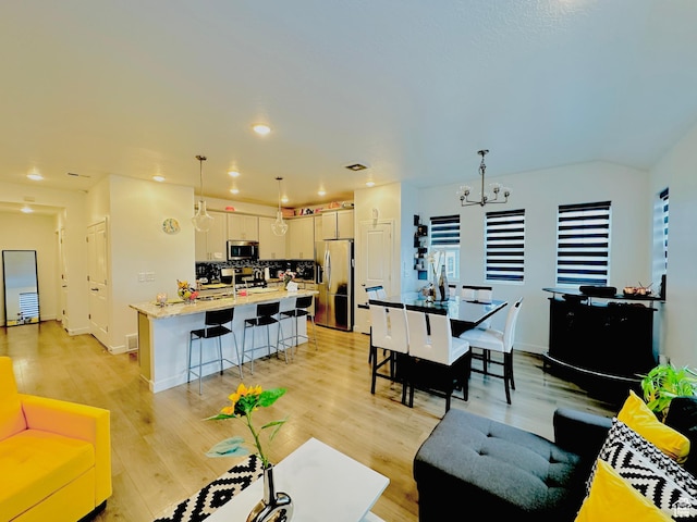 11587 S Prosperity Rd W, South Jordan, UT 84009 - living room with light hardwood / wood-style flooring and an inviting chandelier
