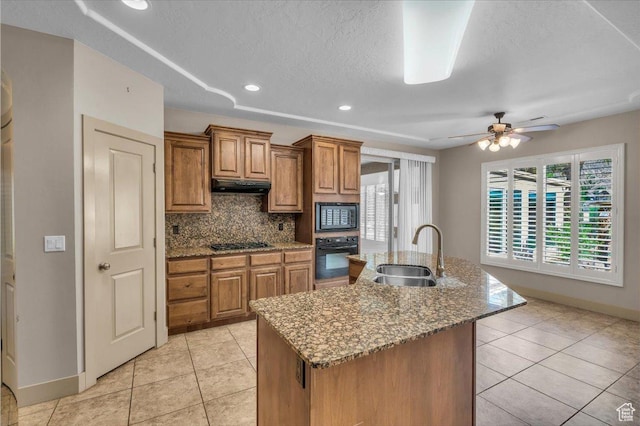 699 E Lost Dr, Washington, UT 84780 - kitchen with under cabinet range hood, brown cabinets, black appliances, a sink, and baseboards