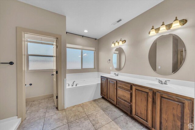699 E Lost Dr, Washington, UT 84780 - full bathroom featuring tile patterned flooring, double vanity, a bath, a sink, and visible vents