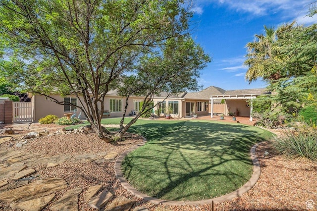 699 E Lost Dr, Washington, UT 84780 - rear view of property featuring a patio, a lawn, stucco siding, and a gate