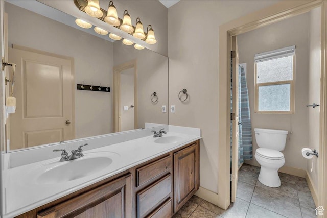699 E Lost Dr, Washington, UT 84780 - bathroom with double vanity, toilet, baseboards, and a sink