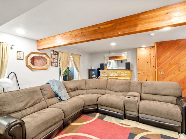 living area with recessed lighting, beamed ceiling, and wood walls