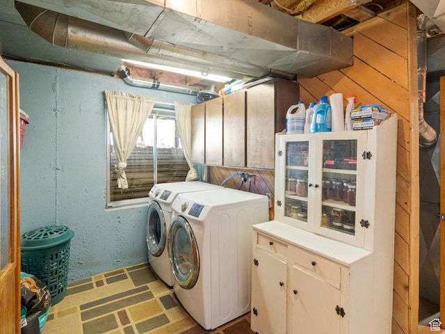laundry area featuring washing machine and dryer and cabinet space