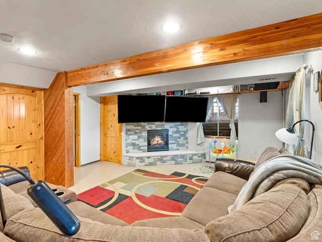 living room with a fireplace and beam ceiling