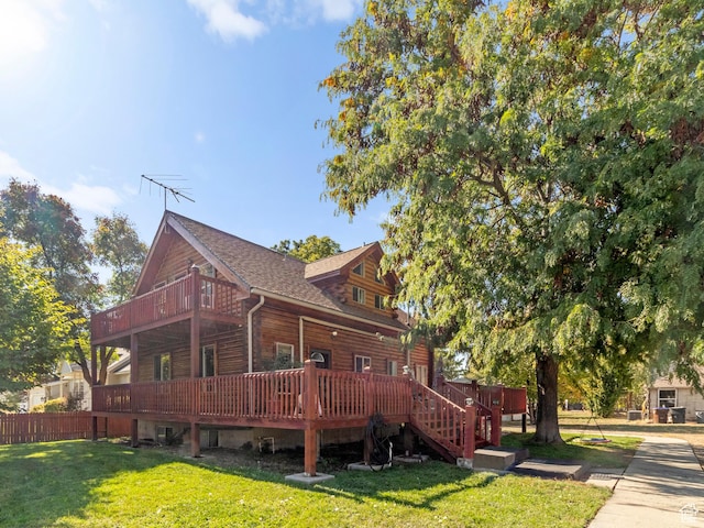 view of side of property featuring stairs, fence, a deck, and a yard