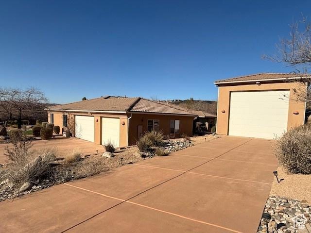 865 Seminole Way S, Washington, UT 84780 - ranch-style home with a tiled roof, a garage, driveway, and stucco siding