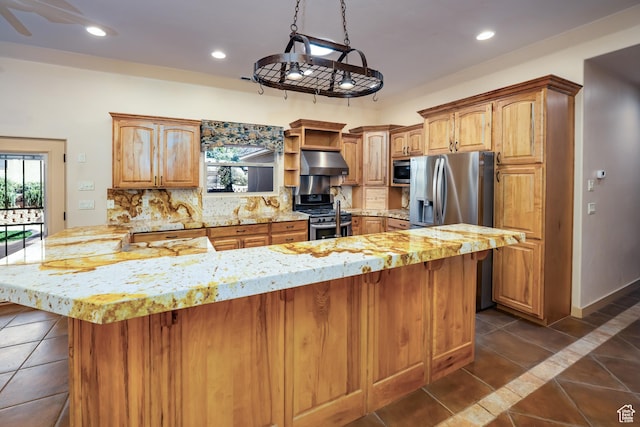 865 Seminole Way S, Washington, UT 84780 - kitchen featuring dark tile patterned floors, a breakfast bar, under cabinet range hood, and stainless steel appliances