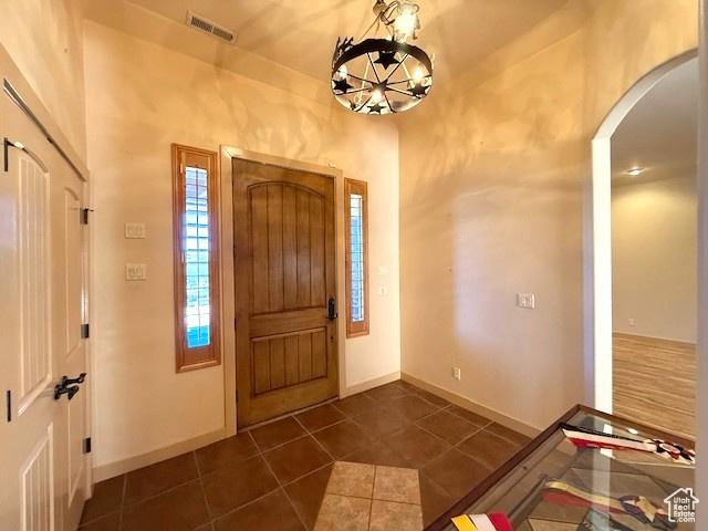 865 Seminole Way S, Washington, UT 84780 - entryway featuring arched walkways, visible vents, dark tile patterned floors, baseboards, and a notable chandelier