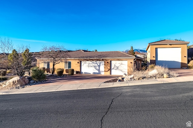 865 Seminole Way S, Washington, UT 84780 - ranch-style house with driveway, a tiled roof, an attached garage, and stucco siding