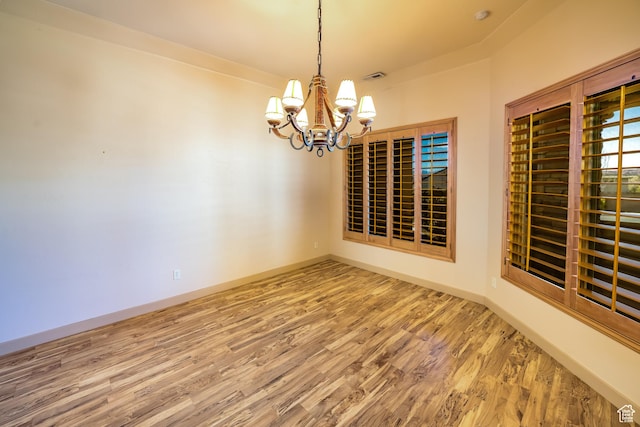 865 Seminole Way S, Washington, UT 84780 - unfurnished dining area with visible vents, baseboards, an inviting chandelier, and wood finished floors