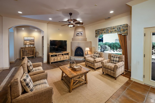865 Seminole Way S, Washington, UT 84780 - tiled living room featuring a large fireplace, recessed lighting, visible vents, ceiling fan, and arched walkways