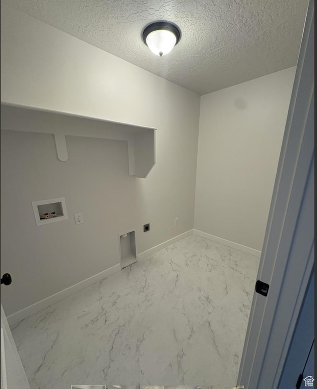 laundry area featuring washer hookup, hookup for an electric dryer, and a textured ceiling
