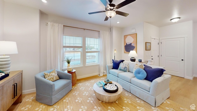 living room featuring ceiling fan and light hardwood / wood-style floors