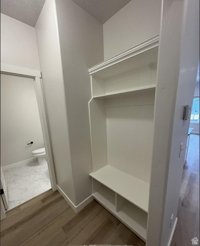 mudroom featuring hardwood / wood-style floors and a textured ceiling