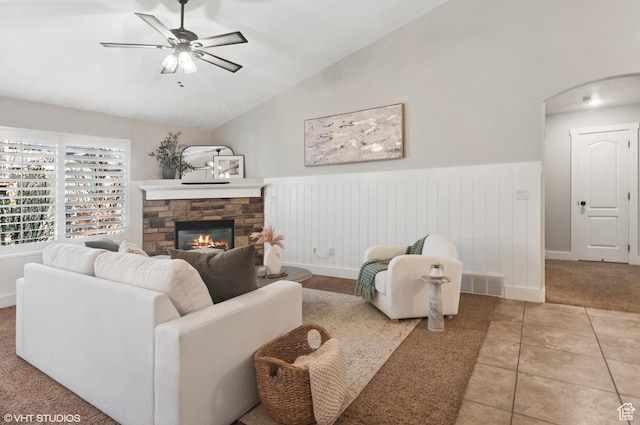 672 W 1900 S, Syracuse, UT 84075 - tiled living area featuring wainscoting, a fireplace, a ceiling fan, and vaulted ceiling