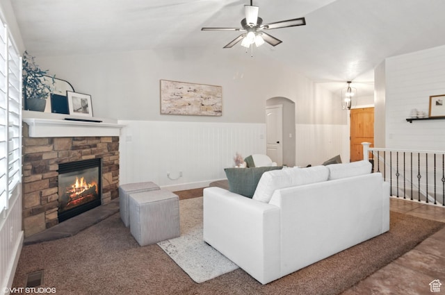 672 W 1900 S, Syracuse, UT 84075 - living room with arched walkways, wainscoting, a fireplace, and vaulted ceiling