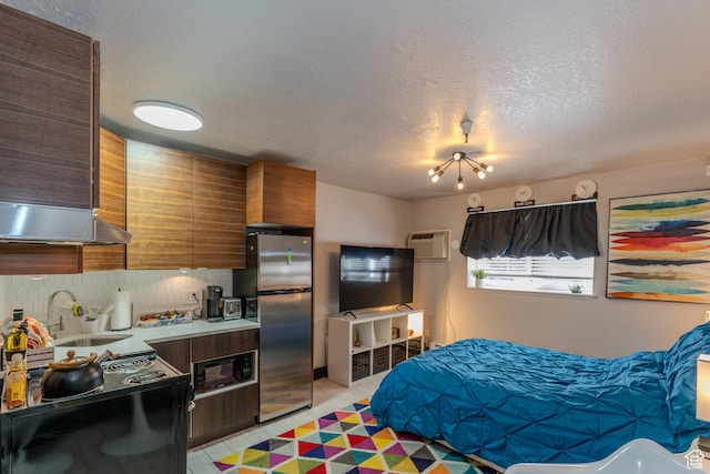 1940 Prospector Ave Unit 108, Park City, UT 84060 - tiled bedroom featuring stainless steel refrigerator, sink, a wall mounted AC, and a textured ceiling