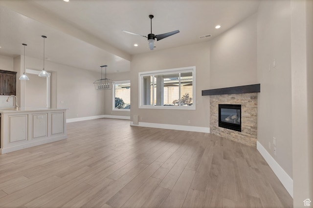 1922 W 430th Cir N, St George, UT 84770 - unfurnished living room with ceiling fan, light hardwood / wood-style flooring, sink, and a fireplace