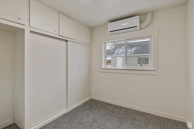 670 16th St, Ogden, UT 84404 - unfurnished bedroom featuring a wall mounted AC, a closet, and carpet flooring