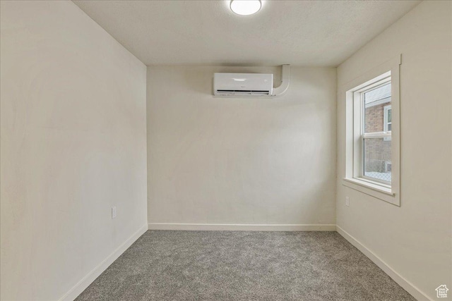 670 16th St, Ogden, UT 84404 - empty room featuring carpet, a textured ceiling, and a wall mounted air conditioner