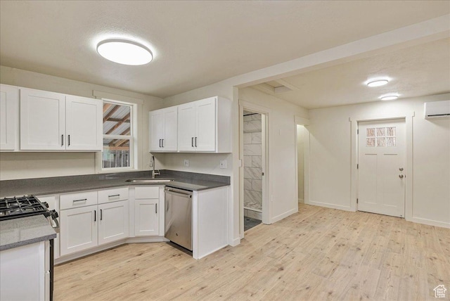 670 16th St, Ogden, UT 84404 - kitchen featuring an AC wall unit, white cabinetry, light wood-type flooring, sink, and stainless steel dishwasher