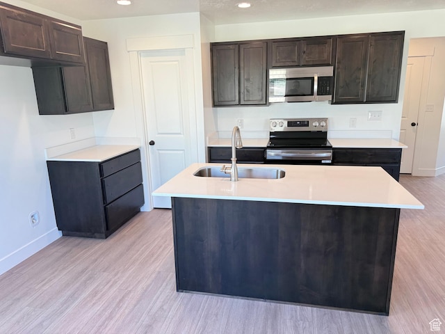 1949 S Freestone Blvd Unit 417, Santaquin, UT 84655 - kitchen with stainless steel appliances, a sink, baseboards, light countertops, and light wood-style floors
