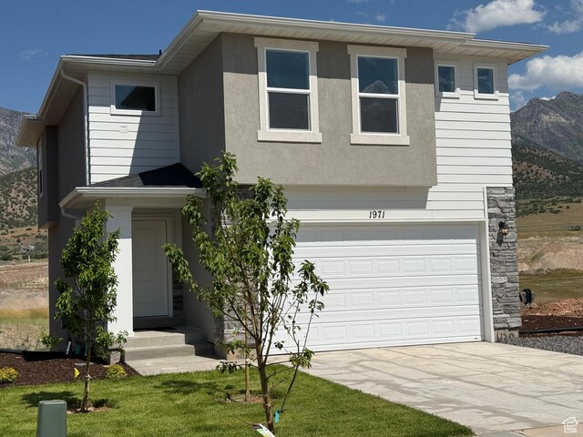 1949 S Freestone Blvd Unit 417, Santaquin, UT 84655 - view of front facade with concrete driveway, a garage, entry steps, a mountain view, and stucco siding