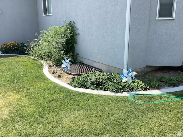 263 E Somerest Ln N, Stansbury Park, UT 84074 - view of home's exterior featuring a lawn
