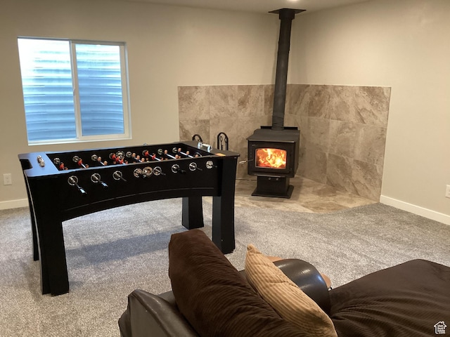 263 E Somerest Ln N, Stansbury Park, UT 84074 - recreation room featuring carpet flooring and a wood stove