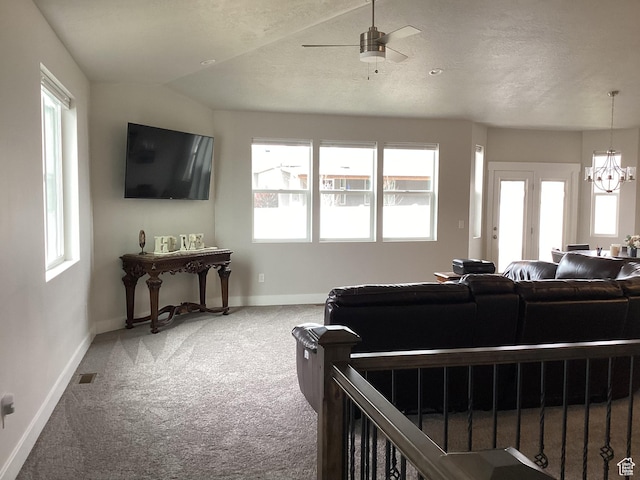 263 E Somerest Ln N, Stansbury Park, UT 84074 - living room with carpet, a healthy amount of sunlight, and ceiling fan with notable chandelier