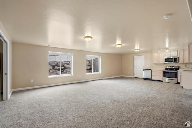 unfurnished living room featuring light carpet