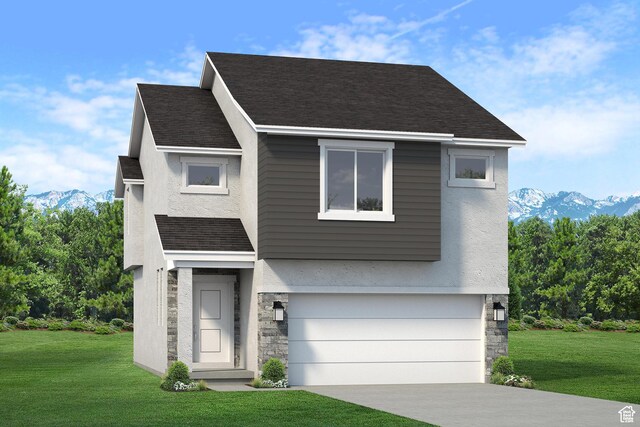view of front of home featuring a mountain view, a front yard, and a garage