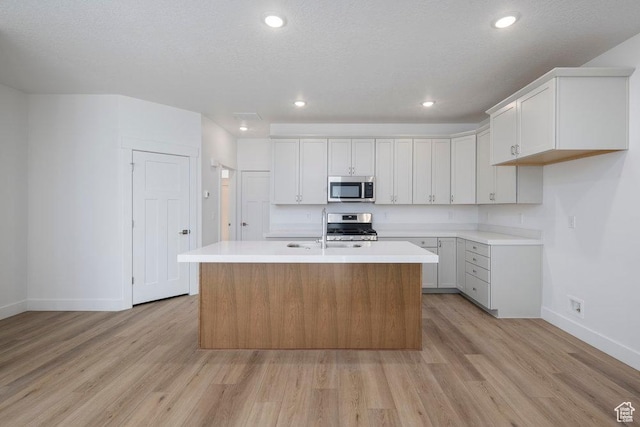 1773 W 160 S Unit 43, Pleasant Grove, UT 84062 - kitchen featuring appliances with stainless steel finishes, light wood-style flooring, and light countertops